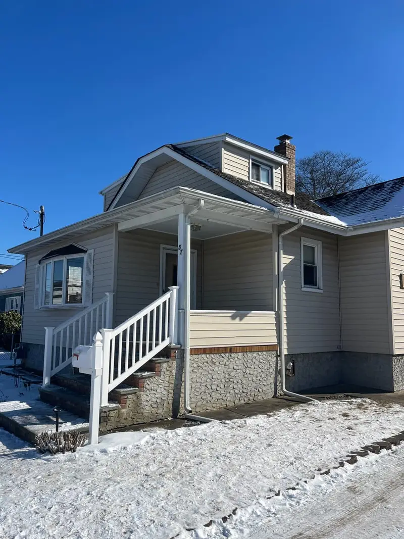 Raised Cape with a front porch and new white stair rails, Lindenhurst, NY